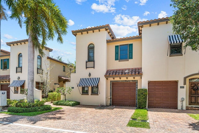 mediterranean / spanish-style house with a garage