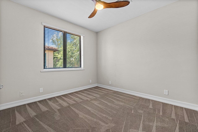 spare room featuring carpet and ceiling fan