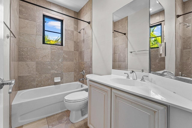 full bathroom with vanity, toilet, and tiled shower / bath