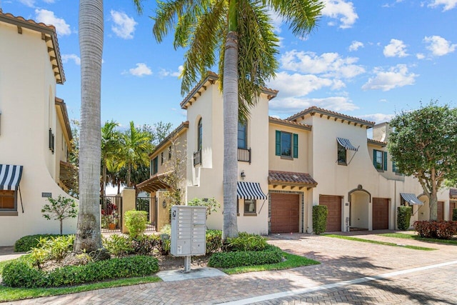 mediterranean / spanish-style home with a garage