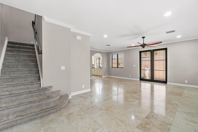 unfurnished living room featuring ceiling fan, crown molding, and french doors