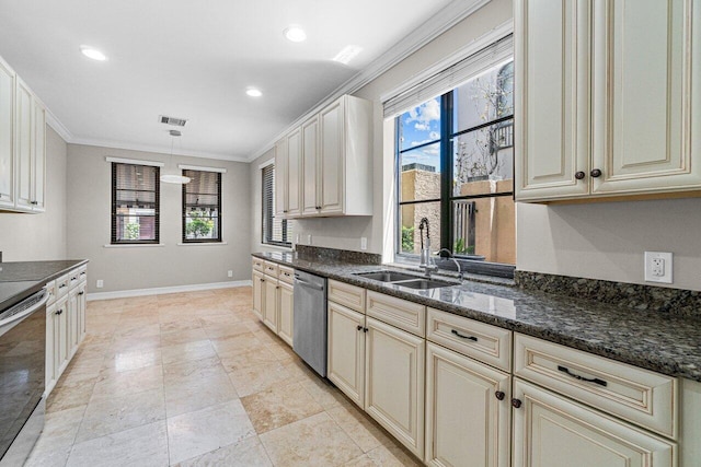 kitchen with pendant lighting, sink, stainless steel appliances, and cream cabinetry