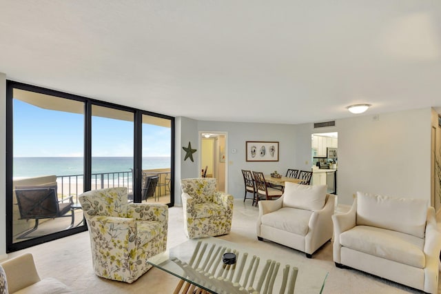 living room with floor to ceiling windows and a water view