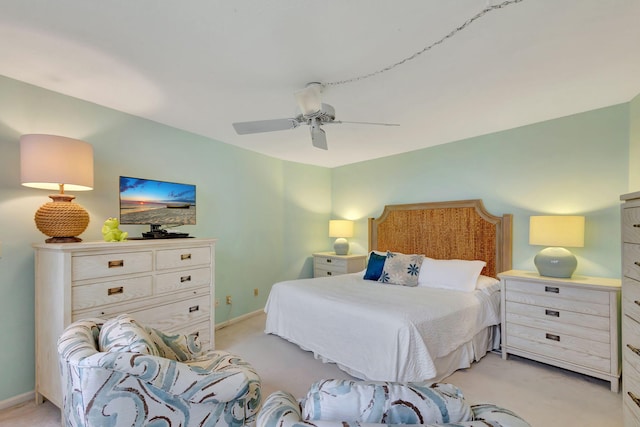 bedroom with ceiling fan and light colored carpet