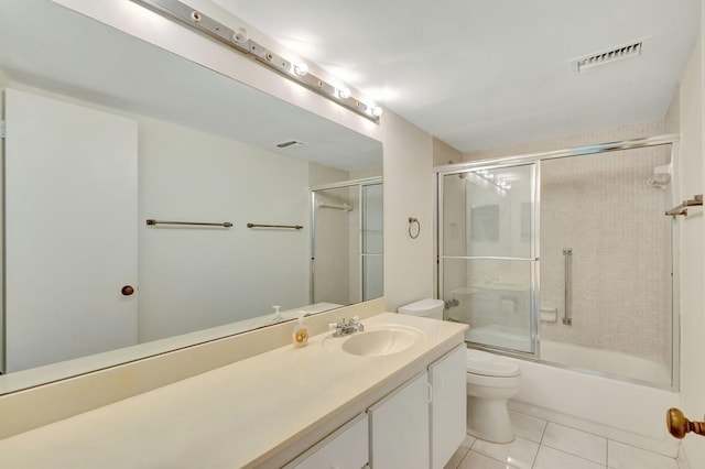 full bathroom with toilet, tile patterned flooring, vanity, and combined bath / shower with glass door