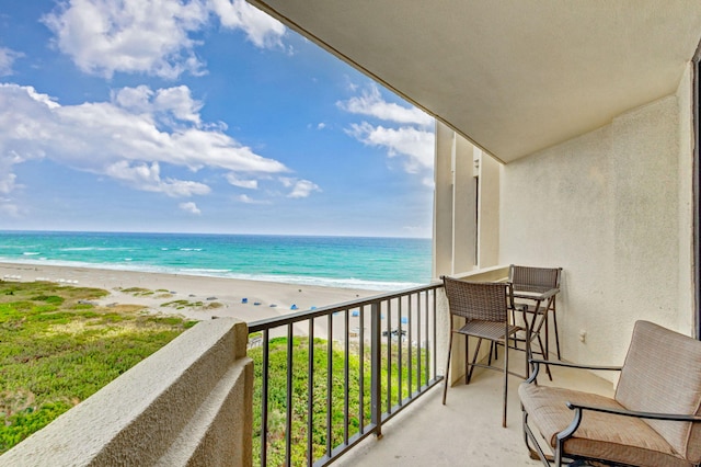 balcony with a beach view and a water view