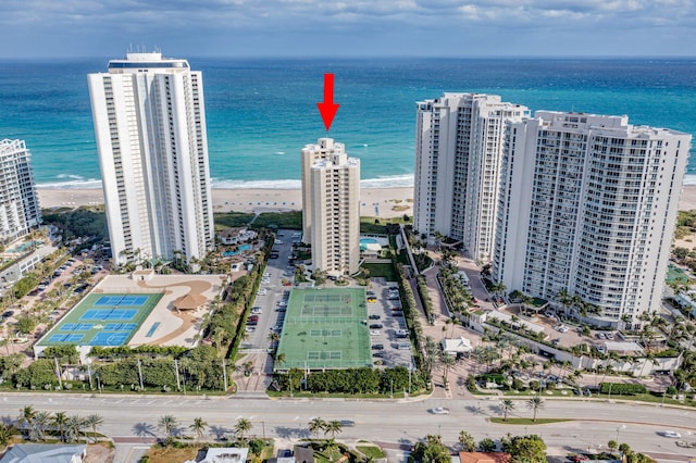 drone / aerial view featuring a water view and a view of the beach