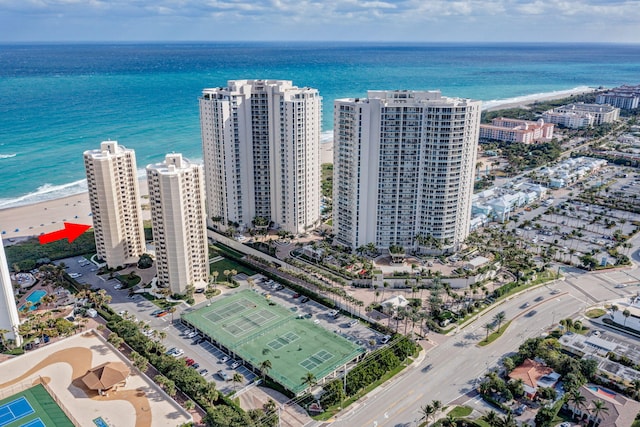 bird's eye view with a water view and a beach view