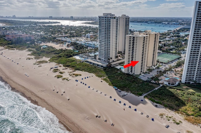 drone / aerial view with a water view and a view of the beach