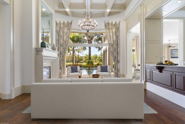 living room with beam ceiling, dark wood-type flooring, coffered ceiling, and an inviting chandelier