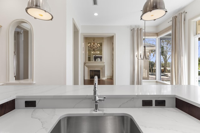 kitchen with light stone countertops and sink