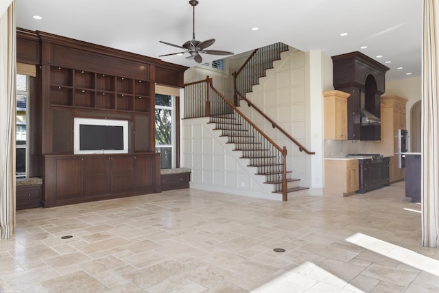 unfurnished living room with ceiling fan