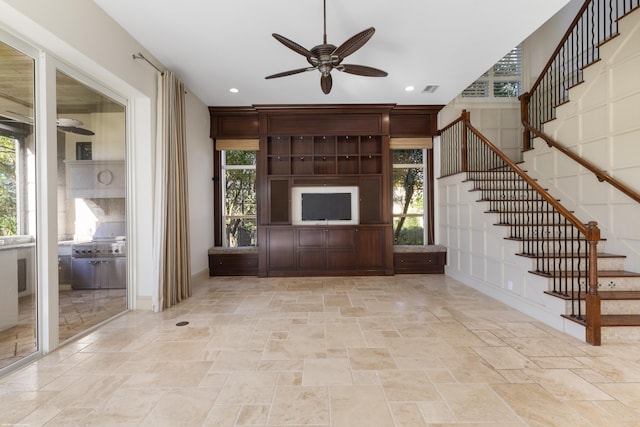 unfurnished living room with ceiling fan