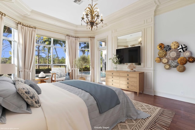 bedroom featuring an inviting chandelier, dark hardwood / wood-style flooring, crown molding, and multiple windows