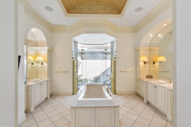 bathroom with a raised ceiling, crown molding, tile patterned flooring, and vanity