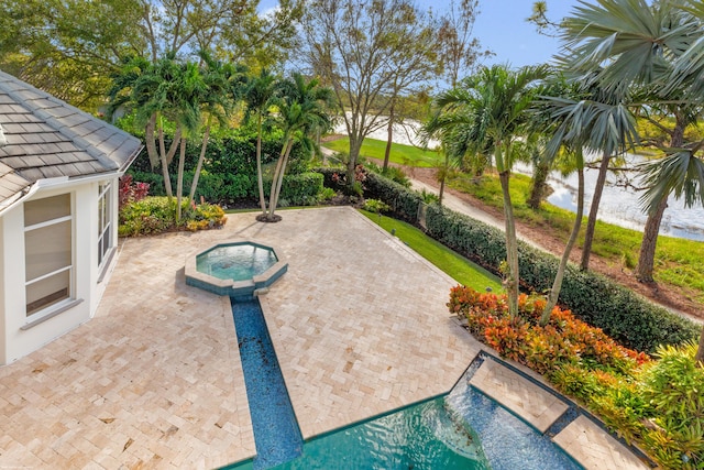 view of swimming pool featuring an in ground hot tub and a patio