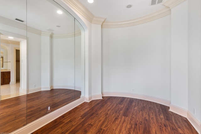 unfurnished room with wood-type flooring and crown molding