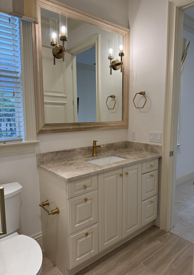 bathroom featuring vanity, a chandelier, and toilet