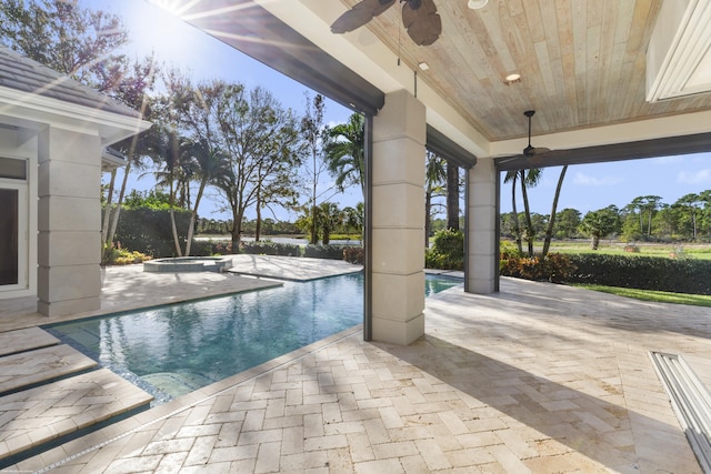 view of pool with ceiling fan, a patio, and an in ground hot tub