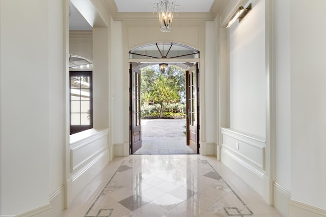 entrance foyer featuring french doors and a chandelier