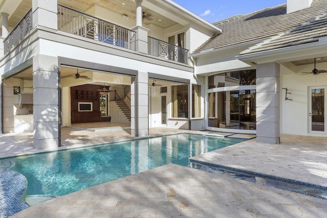 view of swimming pool featuring a patio area and ceiling fan