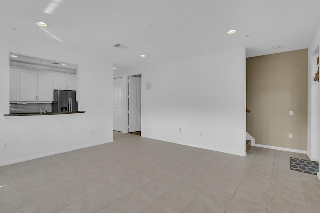 unfurnished living room featuring light tile patterned flooring