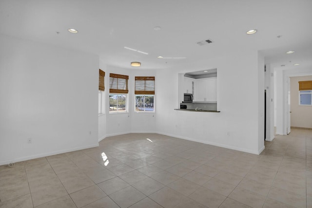 unfurnished living room with light tile patterned floors