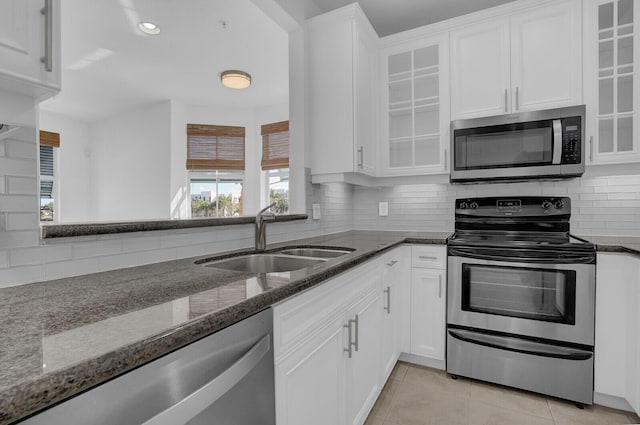 kitchen with white cabinets, dark stone countertops, sink, and appliances with stainless steel finishes