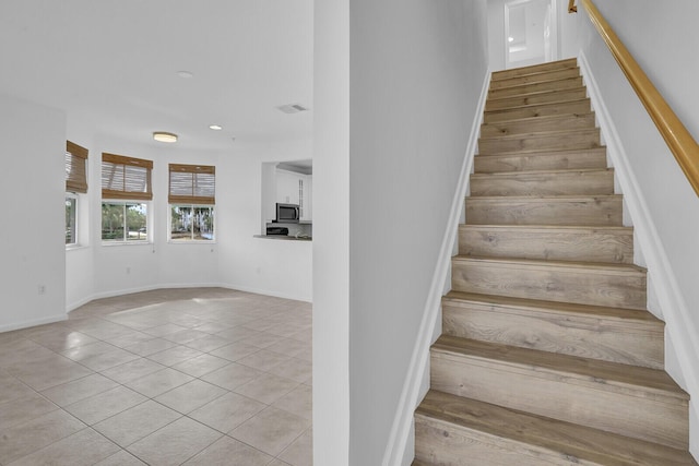 stairs featuring tile patterned flooring