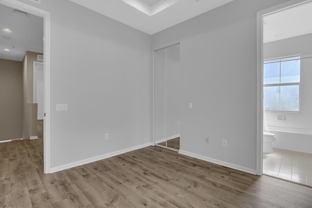 unfurnished room with light wood-type flooring