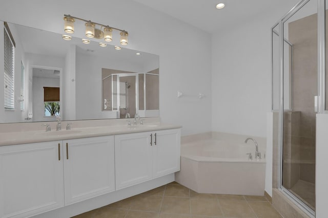 bathroom featuring tile patterned floors, vanity, and shower with separate bathtub