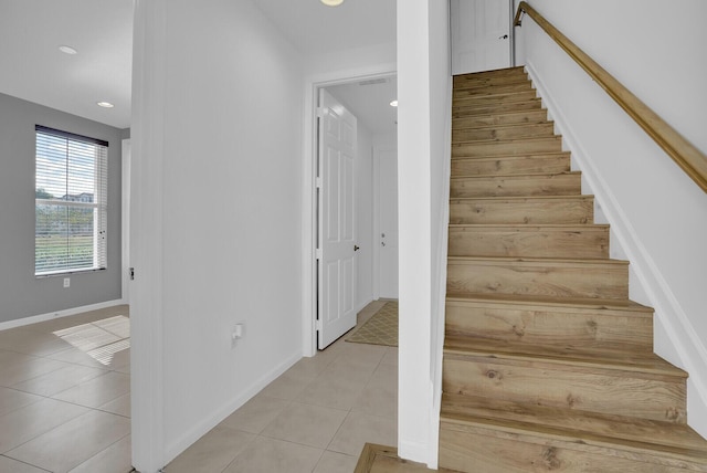 stairs with tile patterned floors