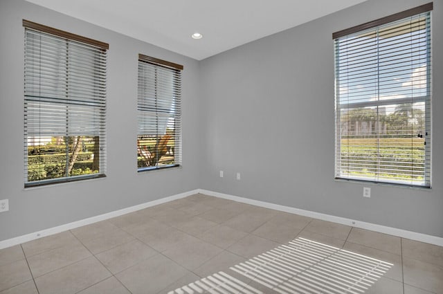 tiled empty room with a healthy amount of sunlight