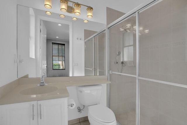 bathroom with tile patterned floors, vanity, toilet, and walk in shower