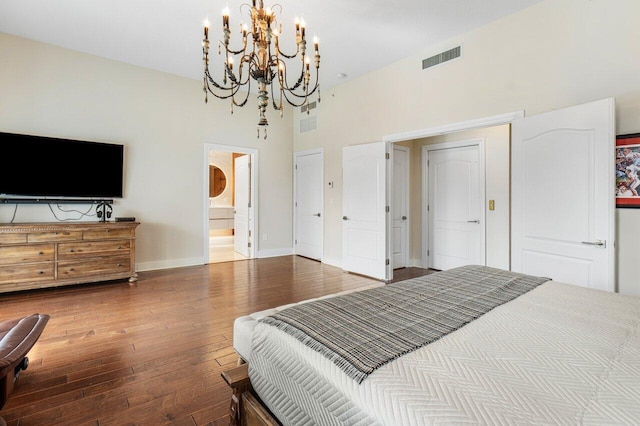 bedroom with hardwood / wood-style flooring and ensuite bath