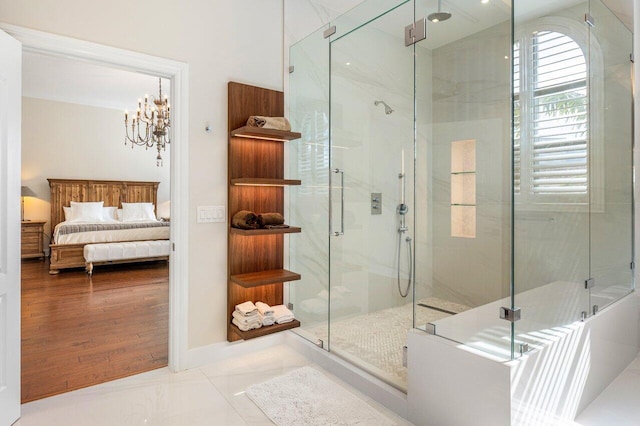 bathroom featuring wood-type flooring, an enclosed shower, and a notable chandelier