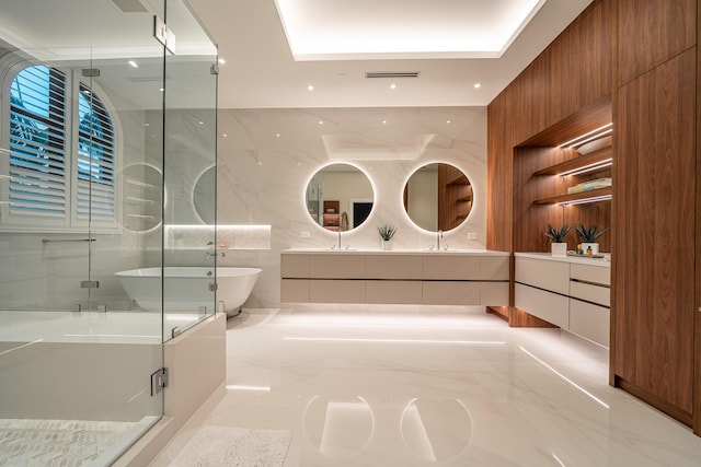 bathroom with vanity and separate shower and tub