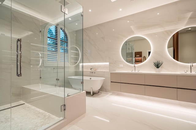 bathroom featuring shower with separate bathtub, tile walls, and vanity