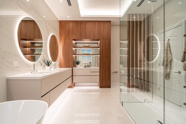 bathroom with vanity, plus walk in shower, and a raised ceiling