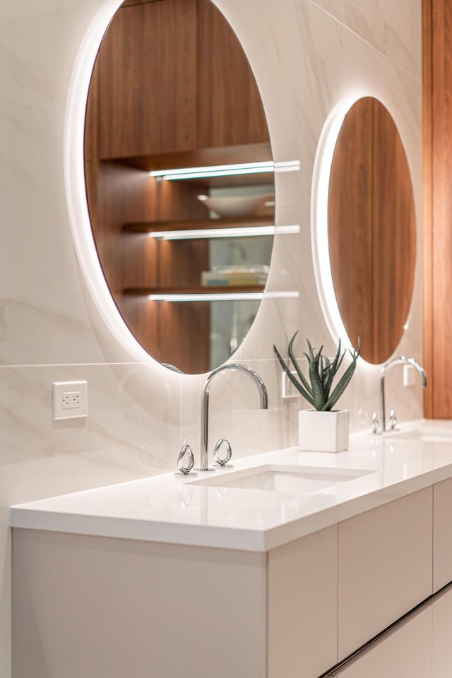 bathroom featuring vanity and tasteful backsplash