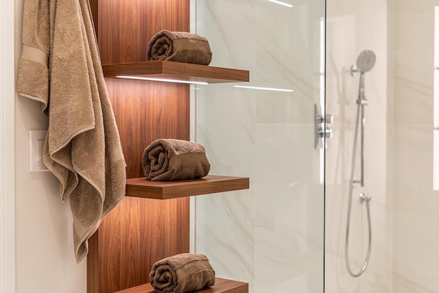 bathroom with a shower with shower door