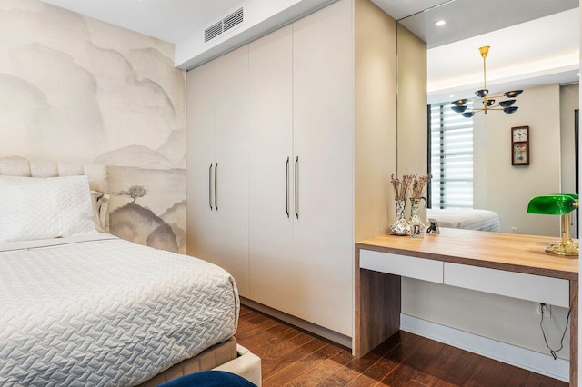 bedroom with dark hardwood / wood-style floors and a closet