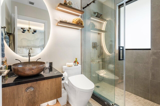 bathroom with vanity, an enclosed shower, and toilet