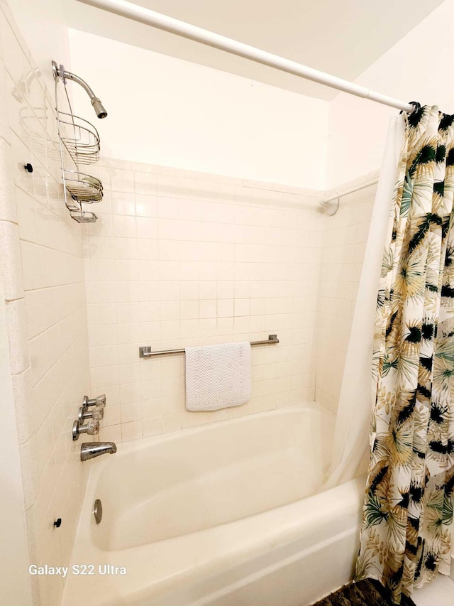 bathroom featuring shower / bathtub combination with curtain