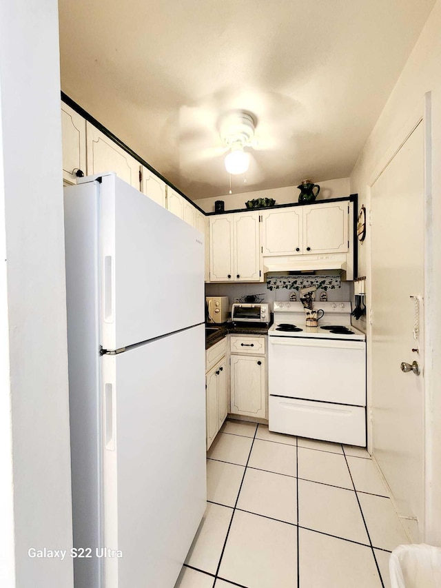 kitchen featuring white cabinets, decorative backsplash, light tile patterned flooring, and white appliances