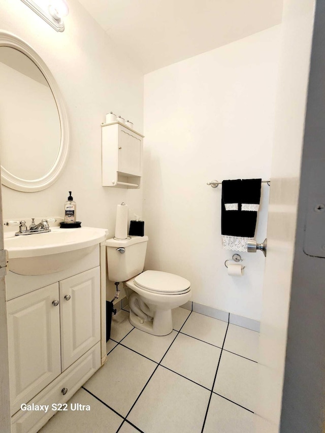 bathroom with tile patterned floors, vanity, and toilet