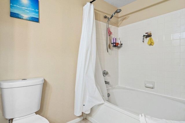 bathroom with toilet and shower / tub combo with curtain