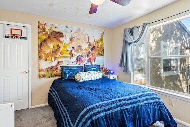 bedroom featuring carpet, multiple windows, and ceiling fan