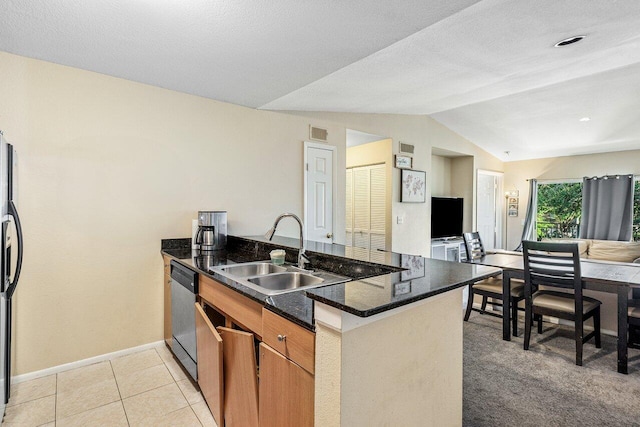 kitchen featuring sink, vaulted ceiling, light tile patterned floors, kitchen peninsula, and stainless steel appliances