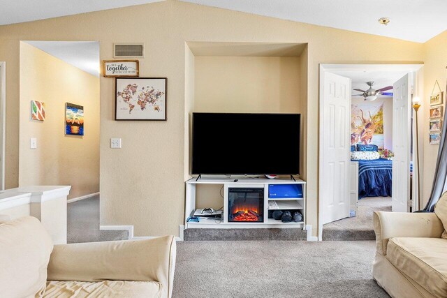 carpeted living room with vaulted ceiling